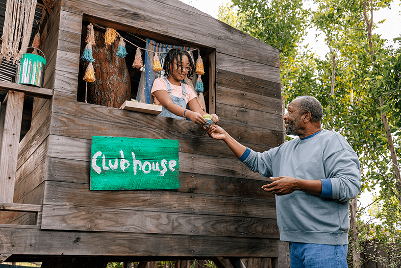 Father and daughter playing in treehouse