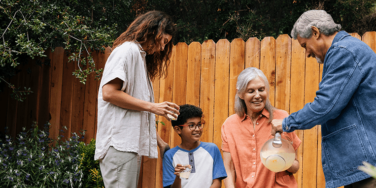 A family having lemonade together in a backyard